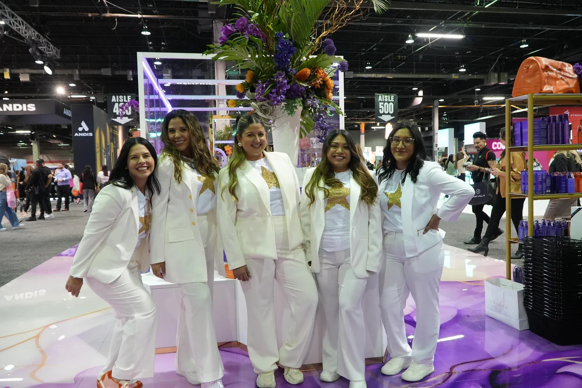 Attractive professional female brand ambassadors in coordinated business attire representing a company on a U.S. trade show floor
