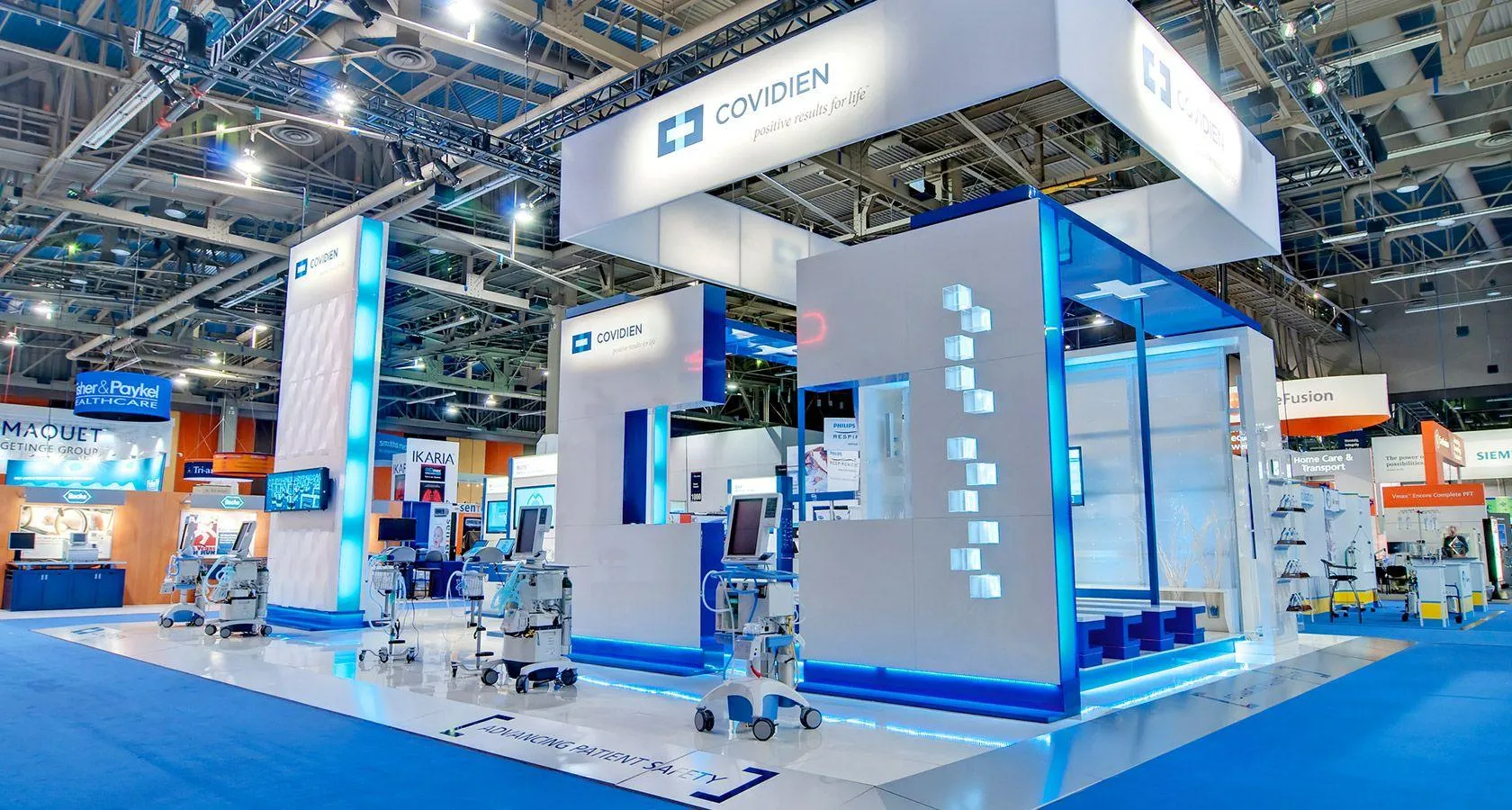 Clinical trade show booth with illuminated displays showcasing professional medical products