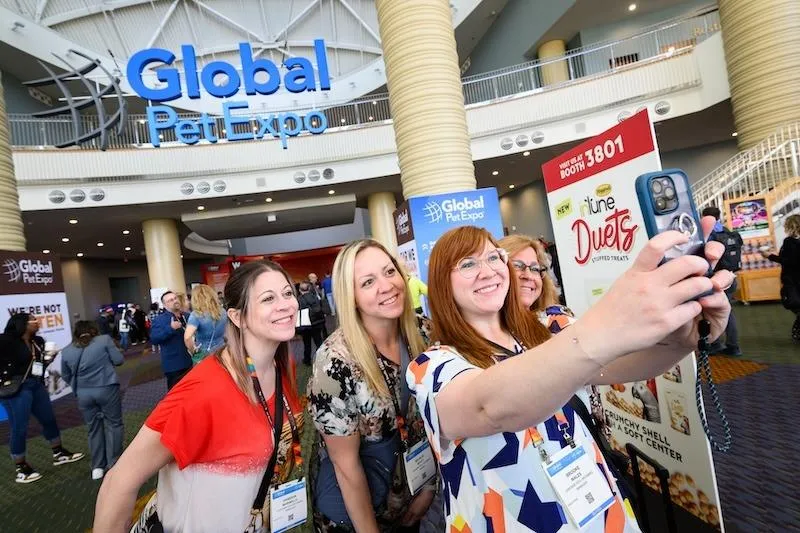 Global Pet Expo show floor in Orlando featuring pet product exhibitors, custom trade show booths, attendees and dogs.