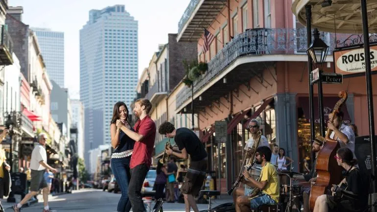 Couple dancing beside live jazz musicians in the French Quarter of New Orleans, Louisiana.