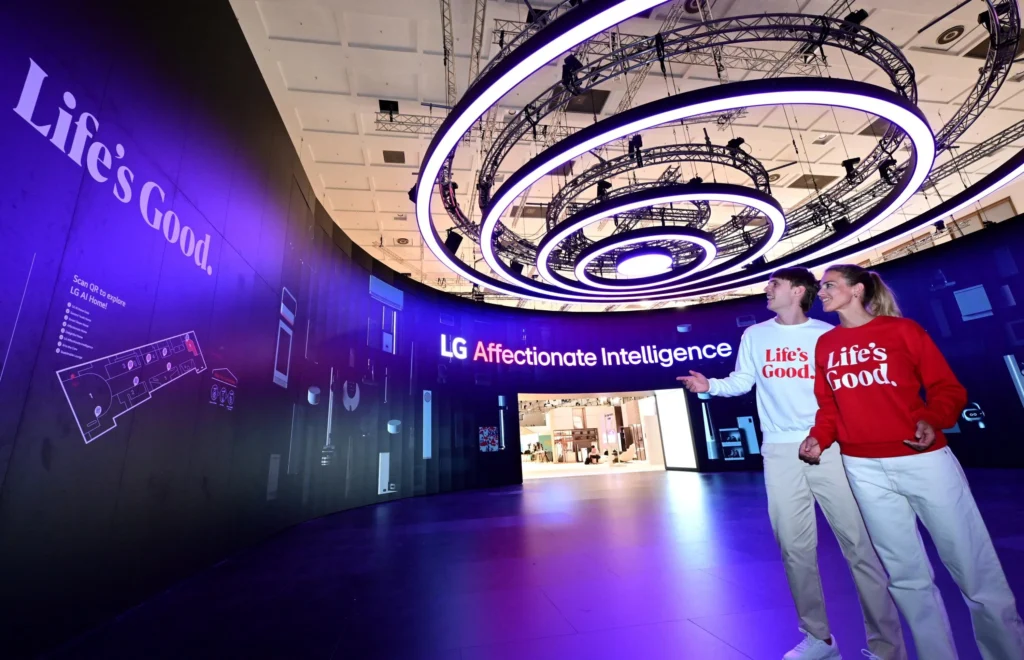 Futuristic custom island trade show booth with illuminated circular overhead rings and open entrances