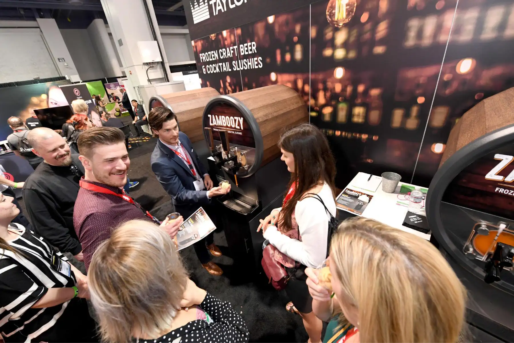 Trade show booth staff engaging a high volume of visitors during a live product sampling