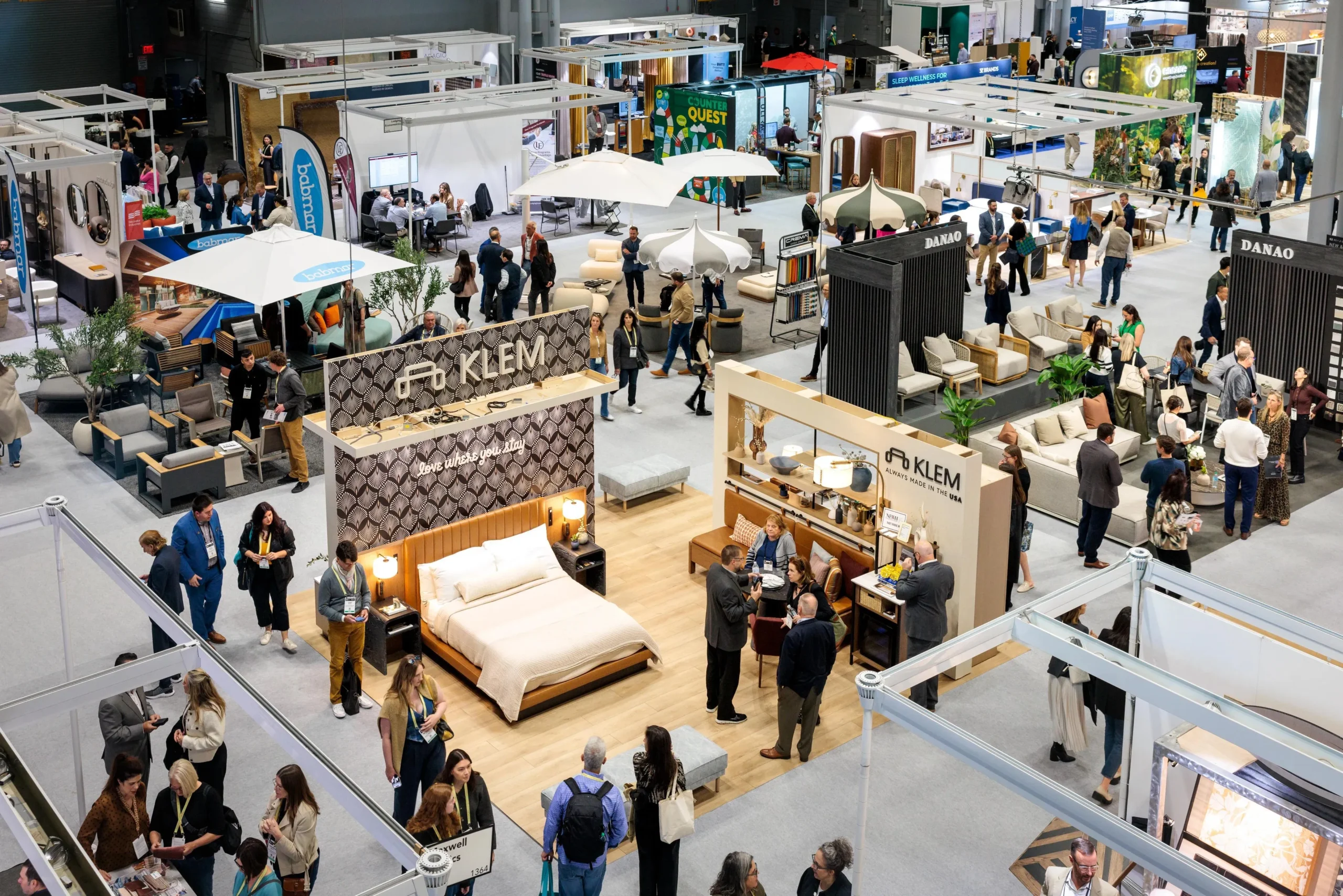 Modern exhibition hall filled with custom trade show booths and business attendees at the Javits Center in NYC.