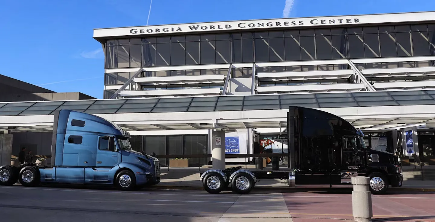 Two commercial semi-trucks outside the Georgia World Congress Center in Atlanta