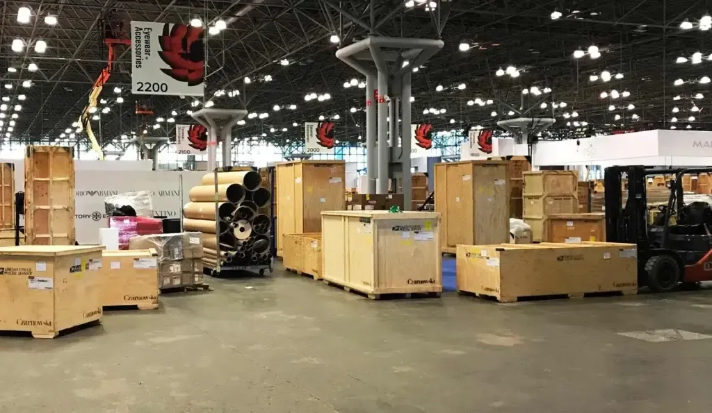 Exhibit crates and forklift on a trade show floor illustrating freight and drayage planning for New Orleans events