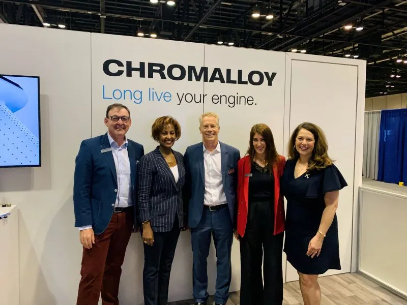 Women of Chromalloy and aviation industry professionals inside the Chromalloy exhibit at MRO Americas