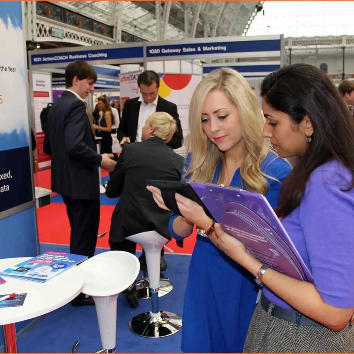 Trade show lead generation staff using a tablet to capture and qualify exhibit visitors