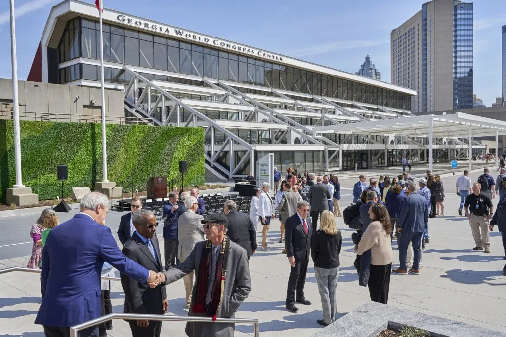 Professional attendees networking outside the Georgia World Congress Center entrance in Atlanta