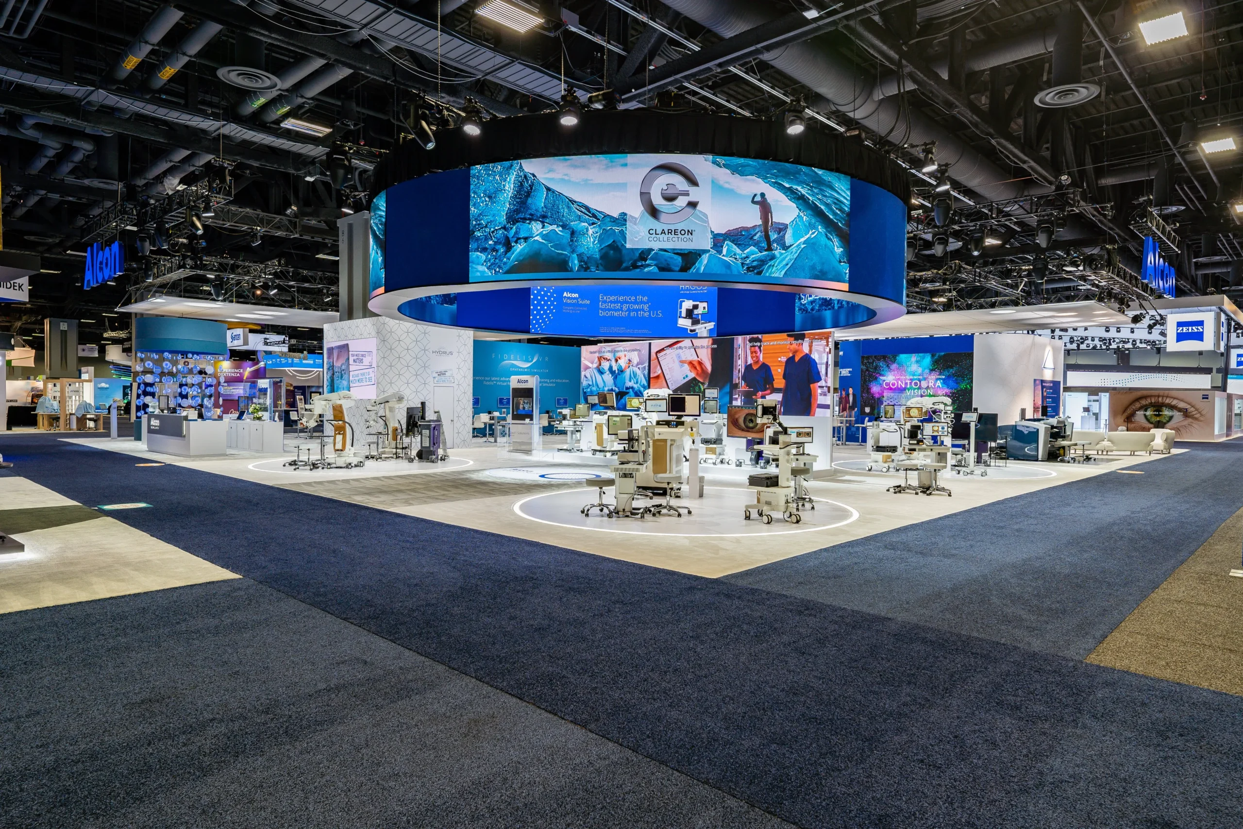 Custom trade show exhibit with circular LED structure and illuminated product platforms