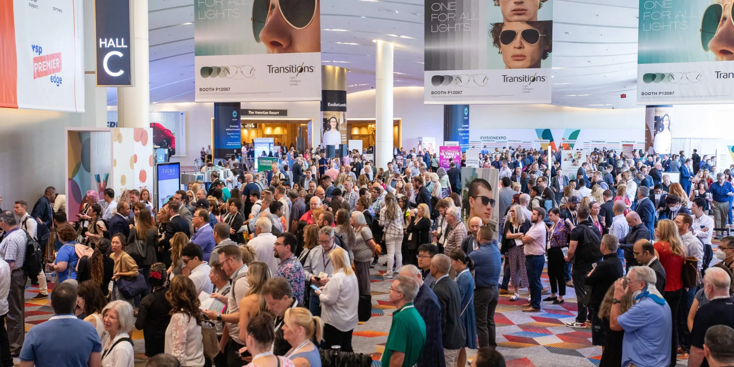 Crowded Vision Expo West show floor in Las Vegas with optical industry exhibitors