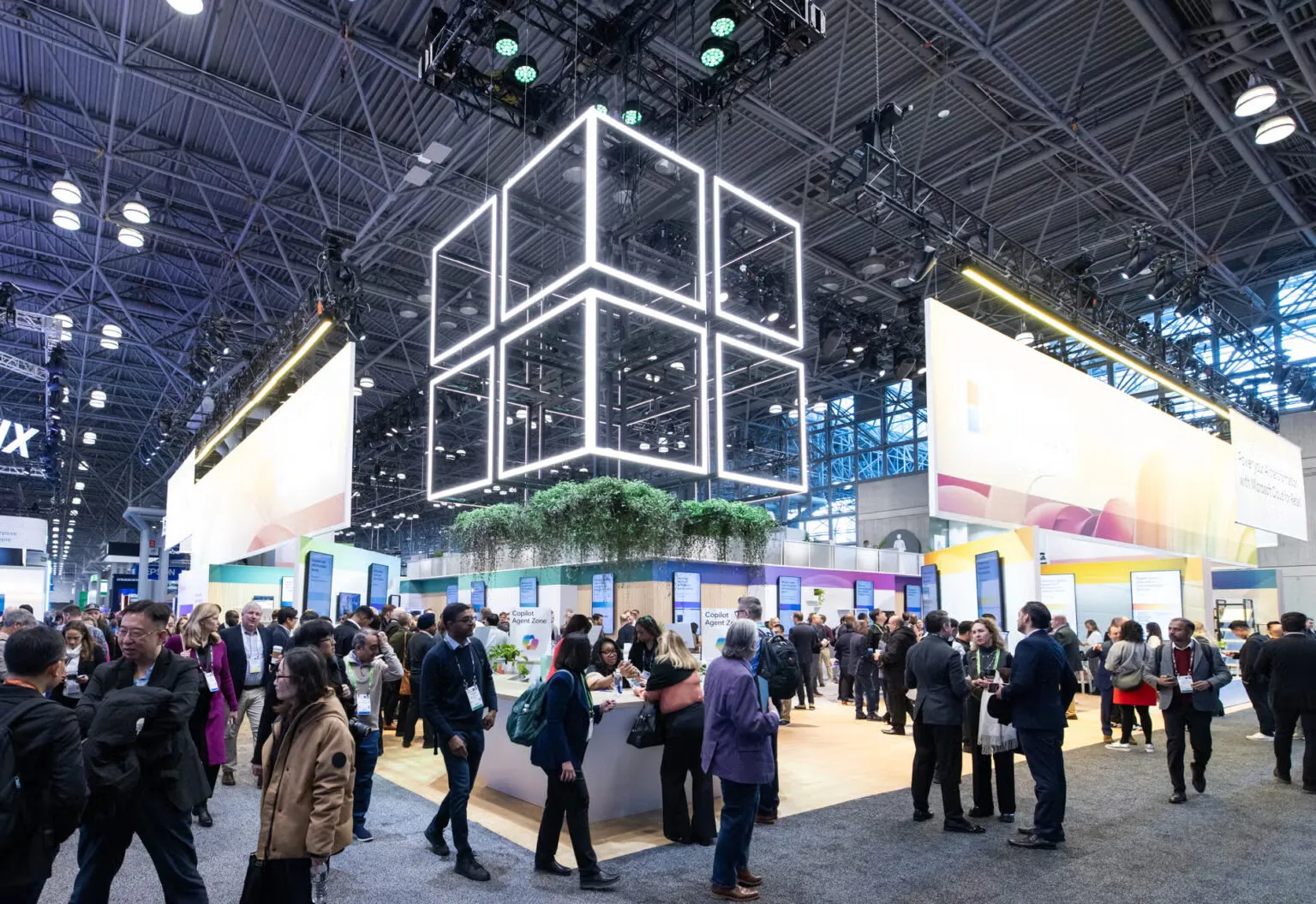 Business professionals networking inside a blue and purple trade show booth