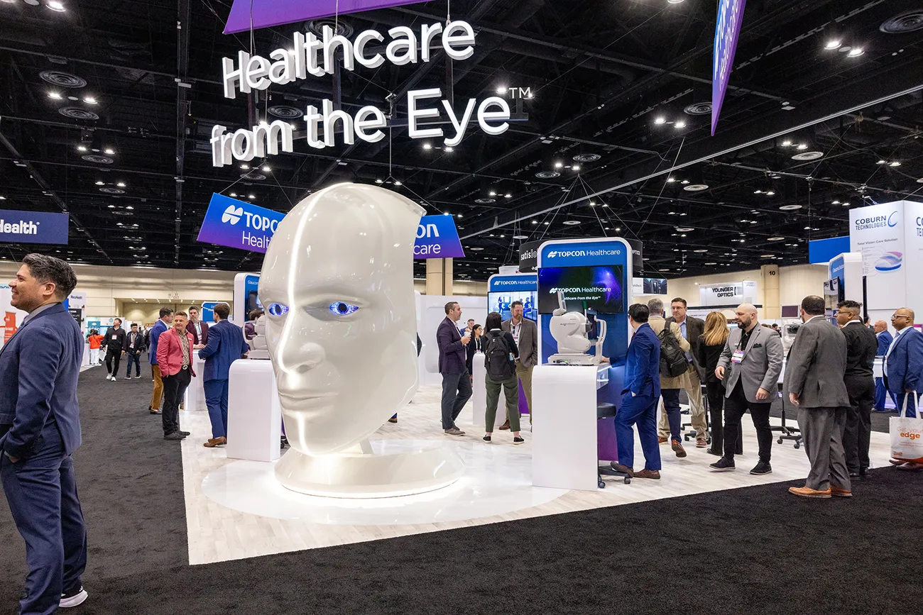 Topcon Healthcare booth at Vision Expo with illuminated eye sculpture and diagnostic displays