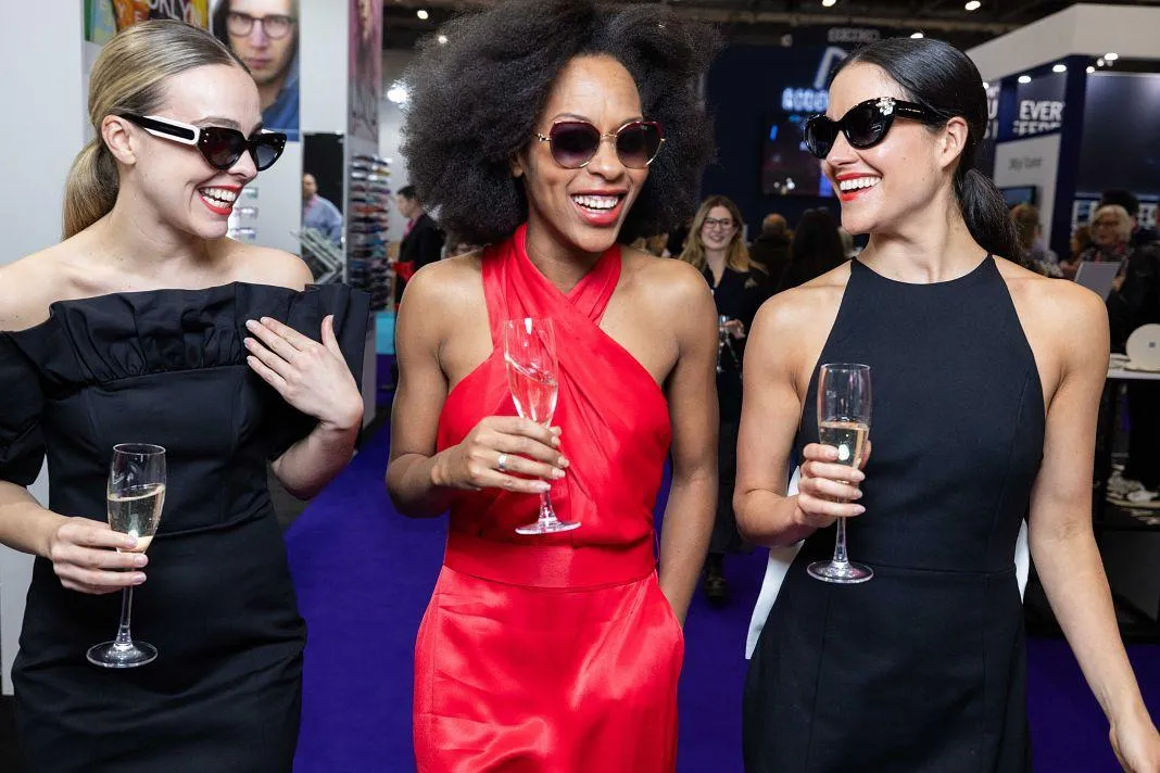 Group of glamorous female models showcasing designer eyewear together at the Vision Expo West runway show in Las Vegas