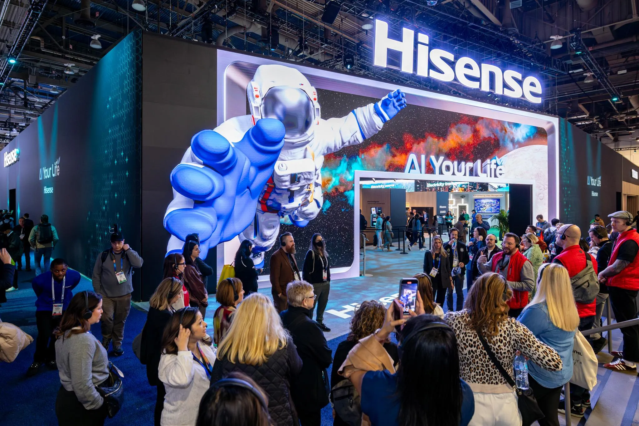 Large Hisense custom exhibit booth at CES in Las Vegas attracting attendees with immersive graphics and live demonstrations