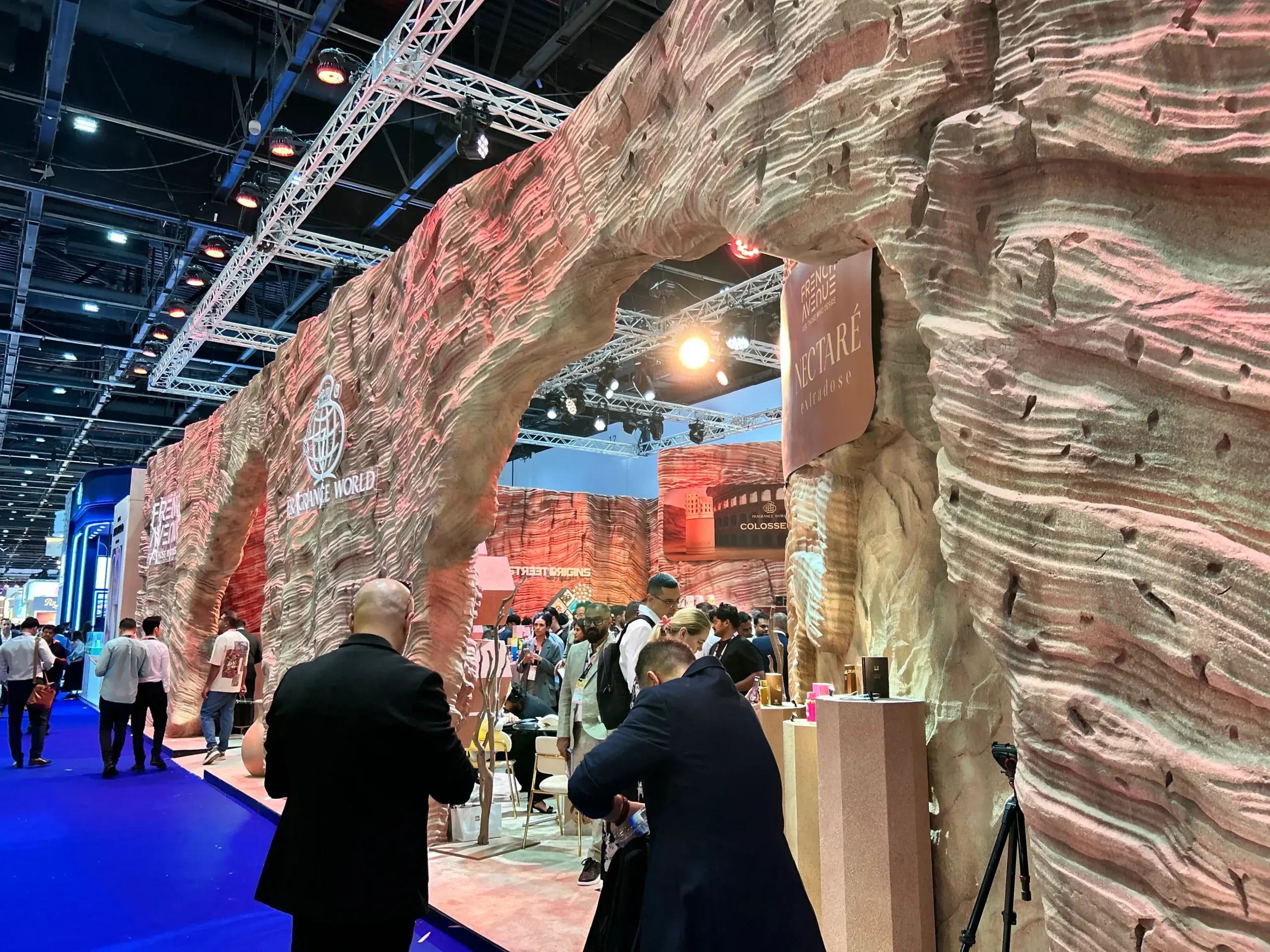 exhibit with sculpted rock archways and visitors exploring the booth