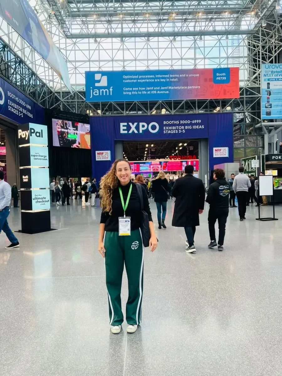 Attractive trade show attendee inside the large Javits Center expo entrance during NRF in New York