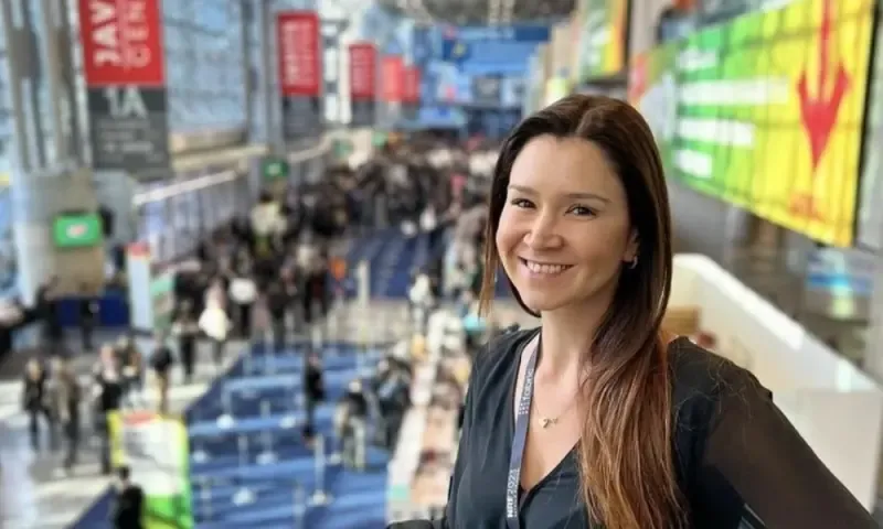 Attractive business exhibitor overlooking the expansive and crowded Javits Center interior in New York