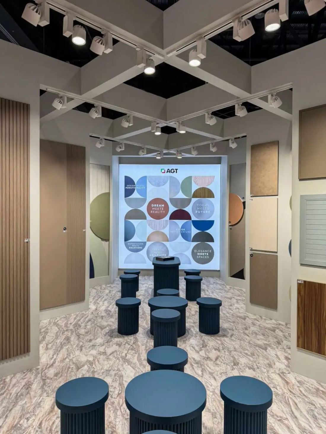 AGT 20x20 island exhibit with a presentation theater, colorful branded screen wall and laminate sample displays