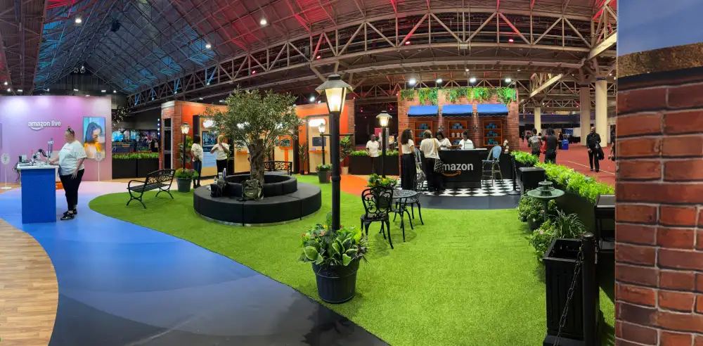 Amazon Live 40x40 streetscape activation with brick storefronts, lamp posts, turf and a live-stream studio