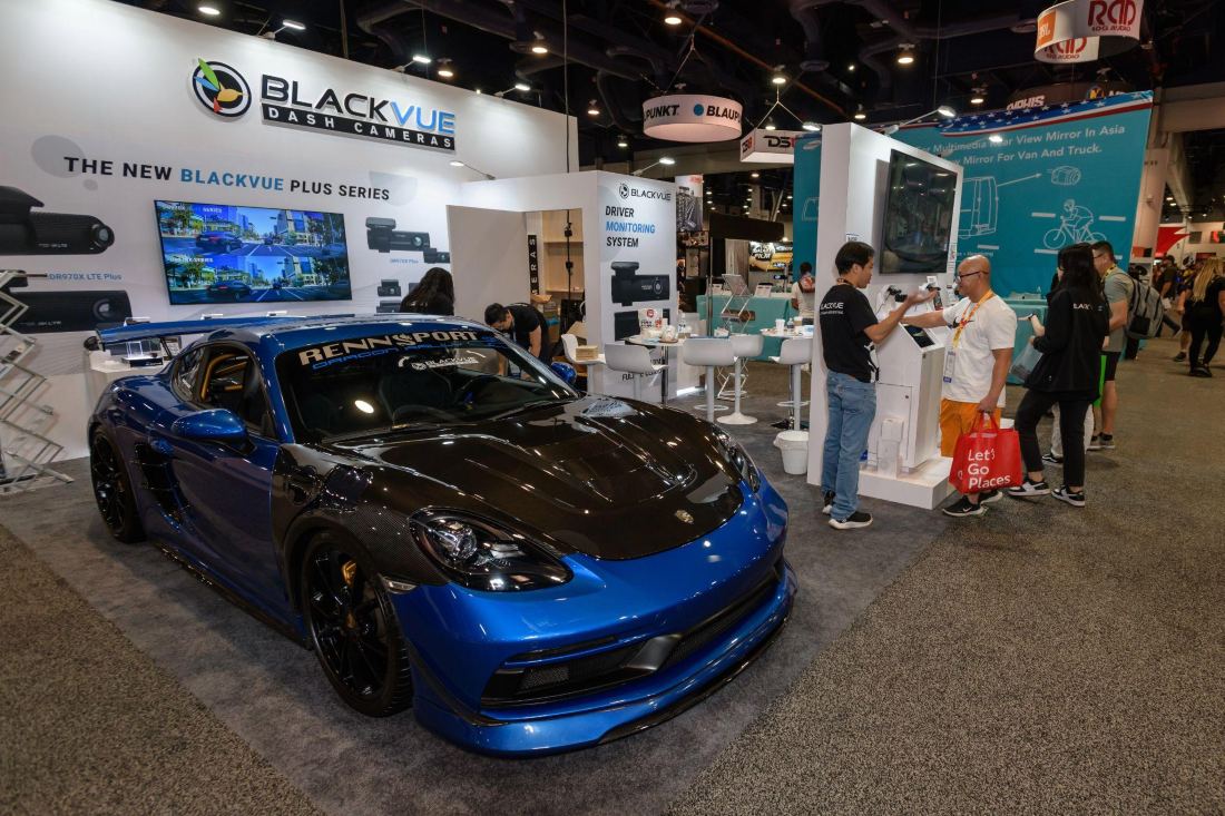 BlackVue 10x20 inline trade show booth at SEMA with a sports car, product wall and video display