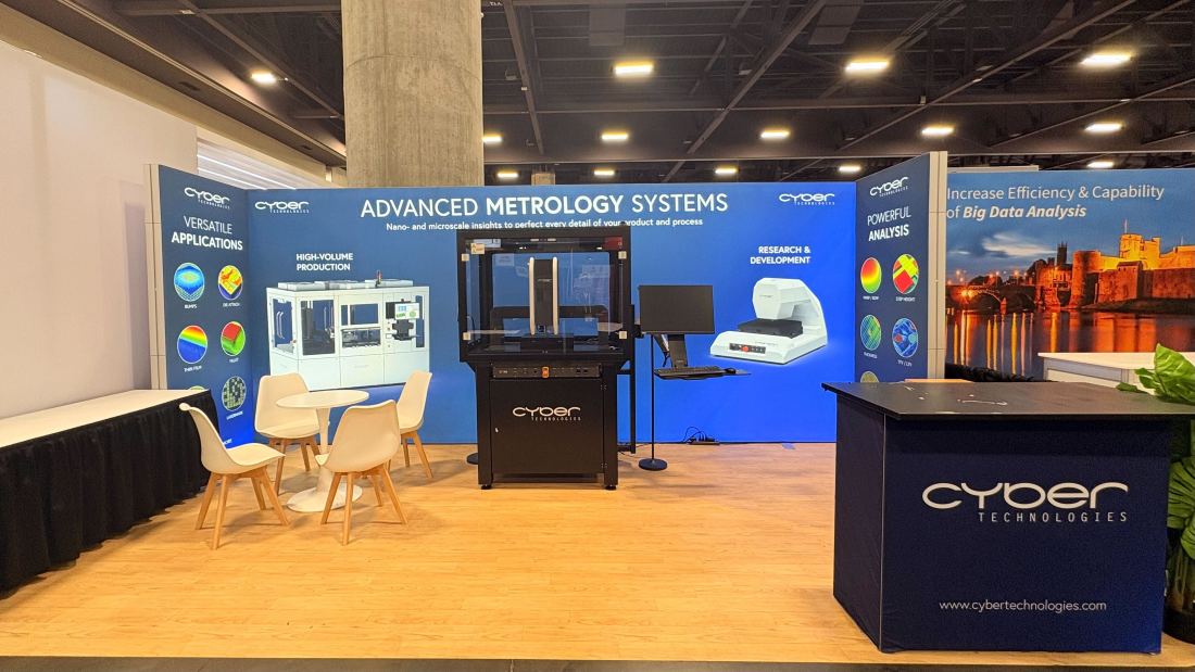 Cyber Technologies 10x10 inline trade show booth with navy graphics and metrology equipment on pedestals