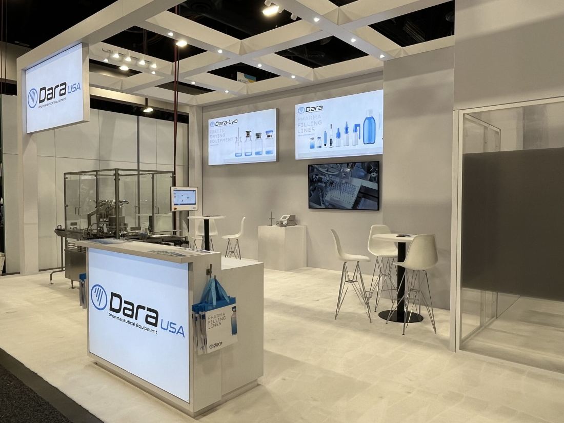 Dara USA 10x20 inline trade show booth with backlit blue graphics, product pedestals and reception counter
