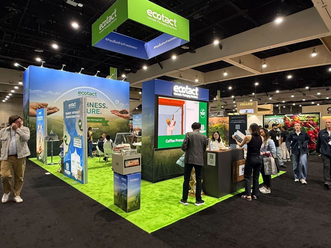 Ecotact 20x20 island trade show exhibit with a hanging cube sign, turf floor and coffee packaging displays