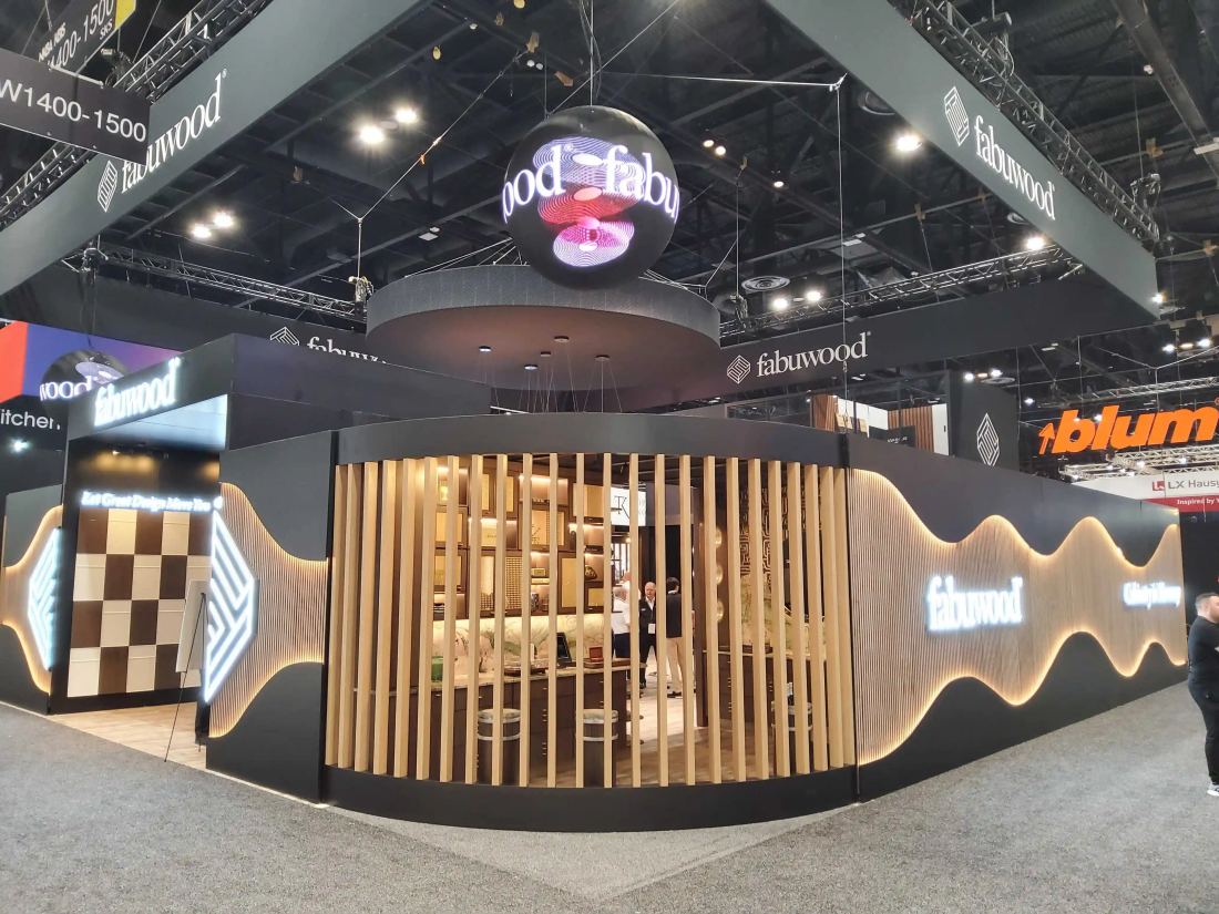 Fabuwood 40x40 island trade show exhibit exterior with a sweeping wave-form wall and glowing sphere sign