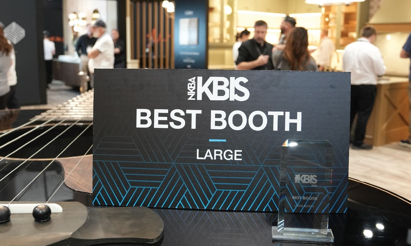 NKBA KBIS Best Booth Large award sign and trophy displayed on a guitar inside the Fabuwood Sound of Home exhibit