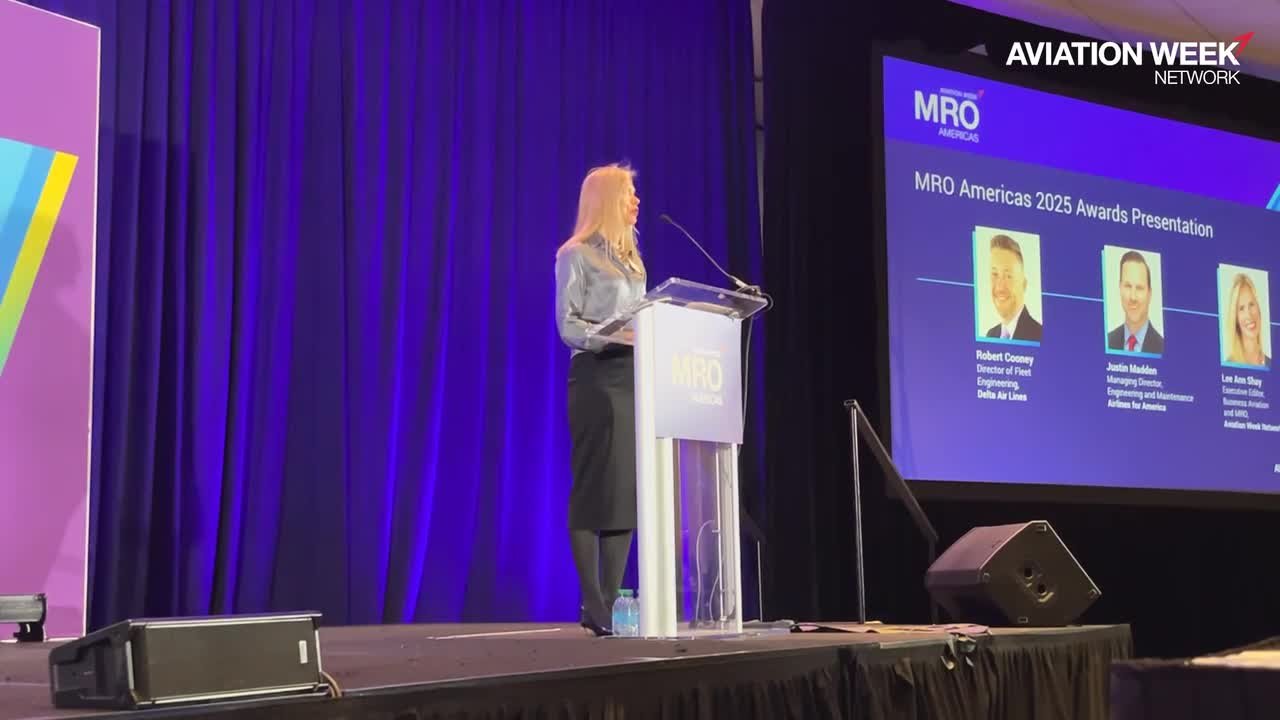 A speaker addresses the MRO Americas 2025 awards presentation from the main stage, with Aviation Week Network and MRO Americas branding behind her.