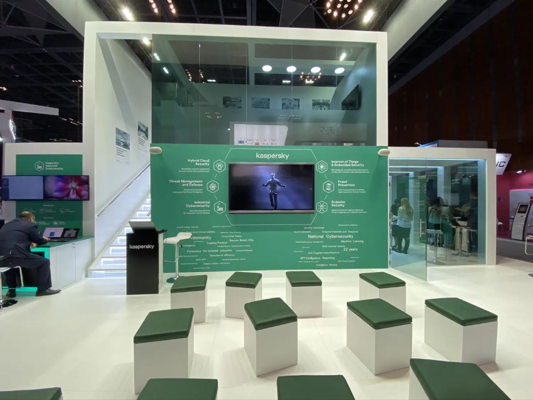Kaspersky 20x30 double-deck island trade show exhibit with a glass upper floor, green presentation wall and theater seating