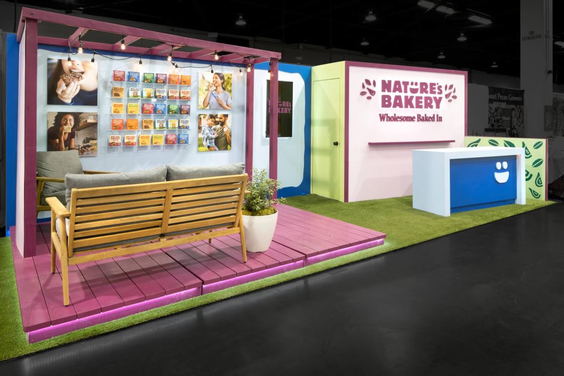 Nature's Bakery 10x20 trade show booth with a porch deck, railings and product shelving