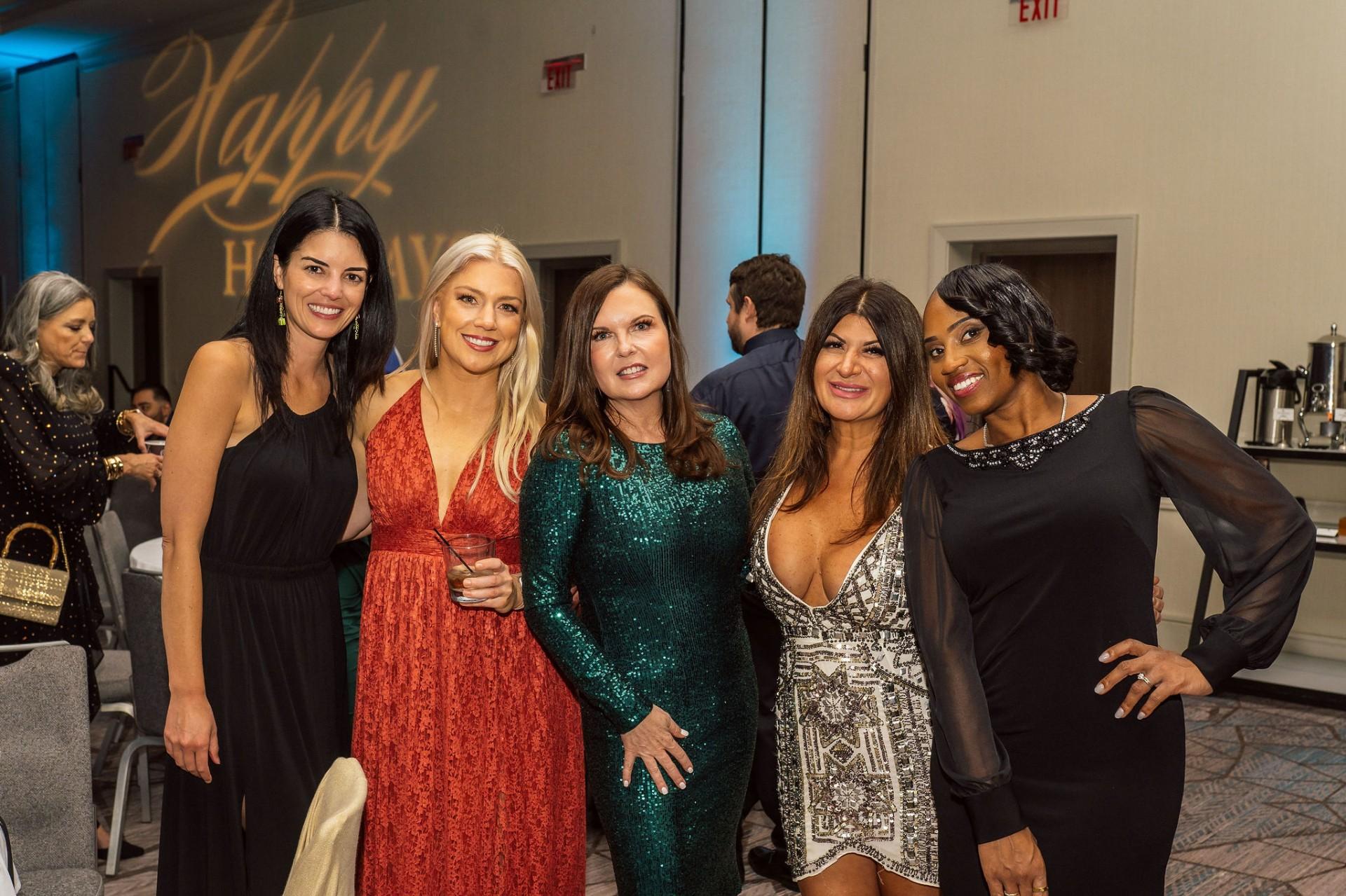 Event industry professionals gathered together at an evening reception in a hotel ballroom.