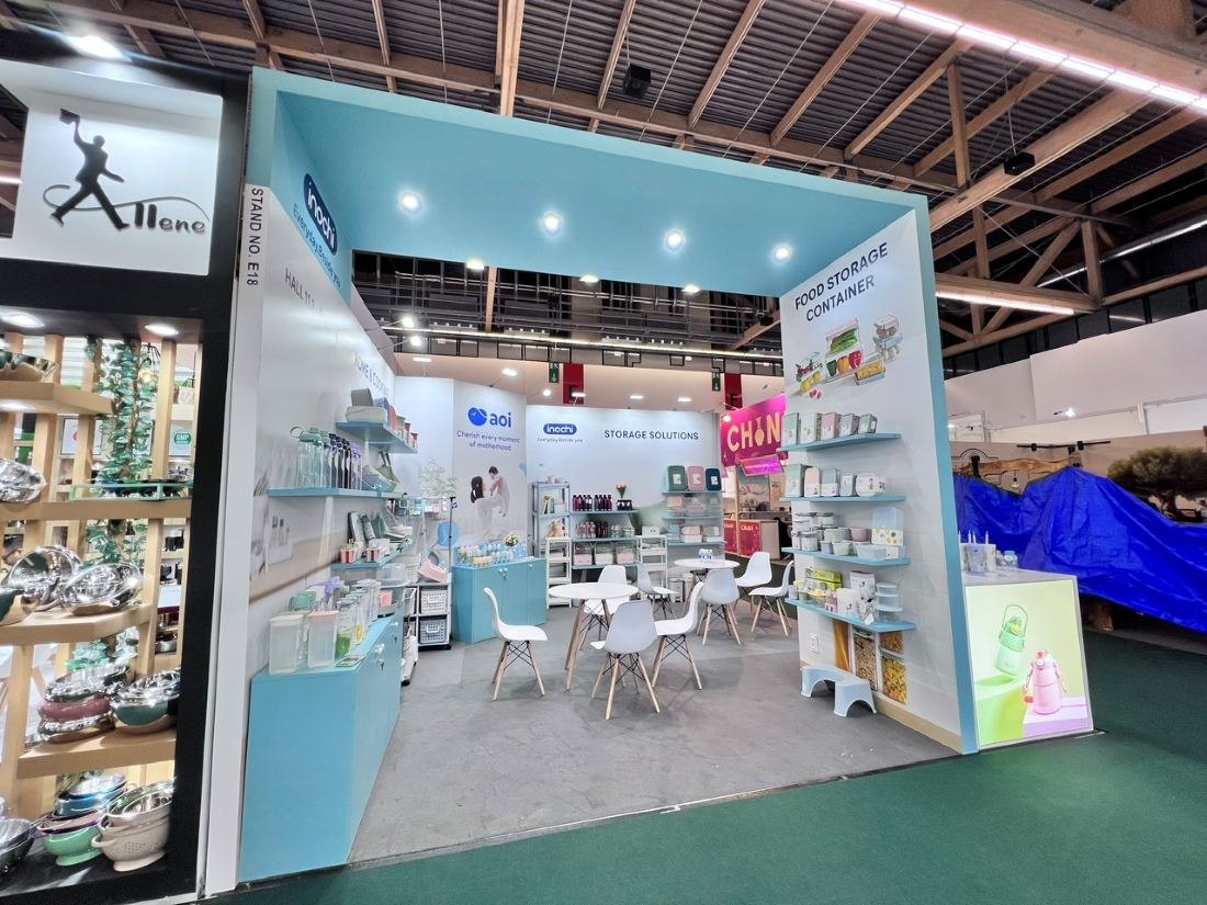 Tan Phu Vietnam 20x20 peninsula trade show booth with white product walls for inochi and aoi housewares