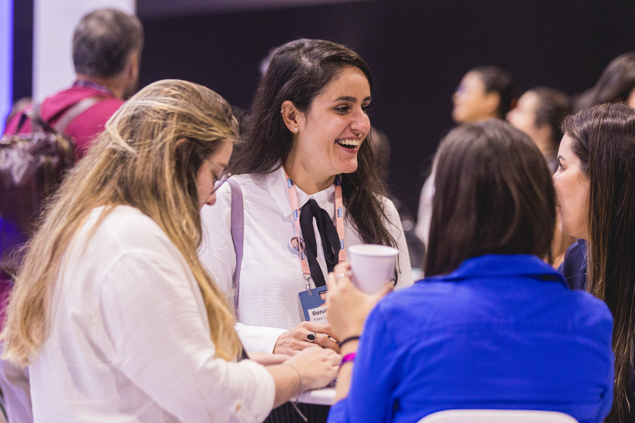 Women having an animated face-to-face conversation at an exhibition meetup