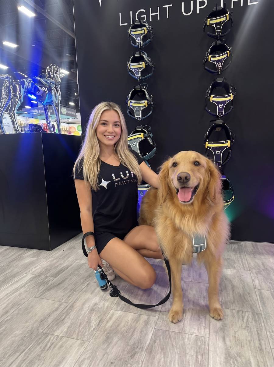 Brand ambassador with a golden retriever at Global Pet Expo