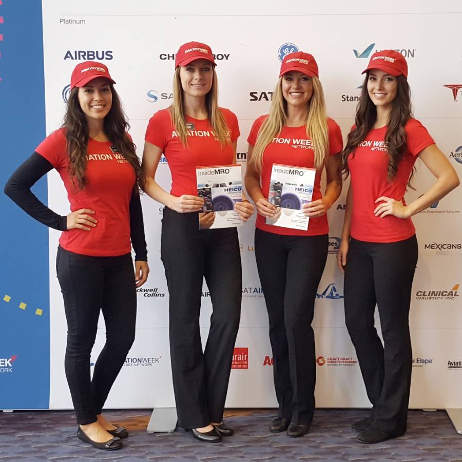 Brand ambassadors in red at an aviation exhibit
