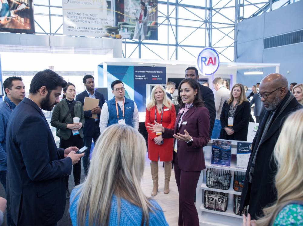 Presenter speaking to visitors at a large exhibit
