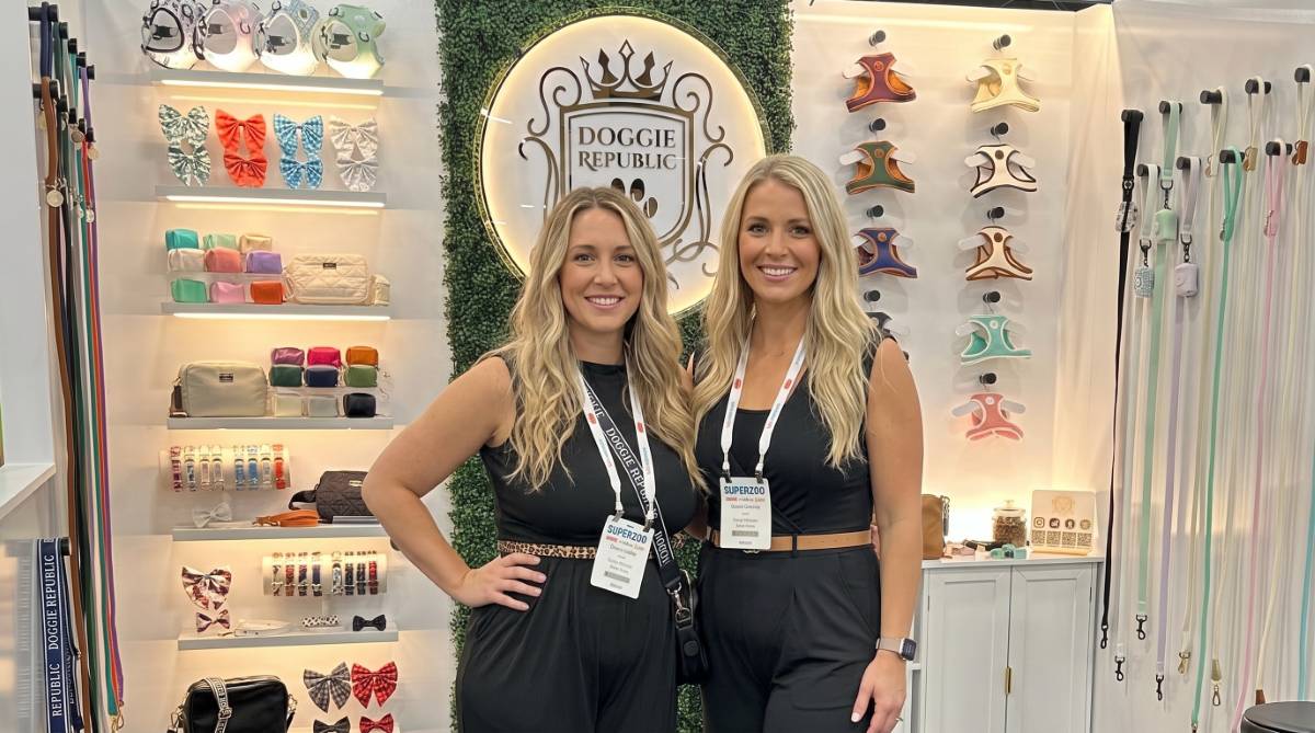 Two models at a pet product exhibit