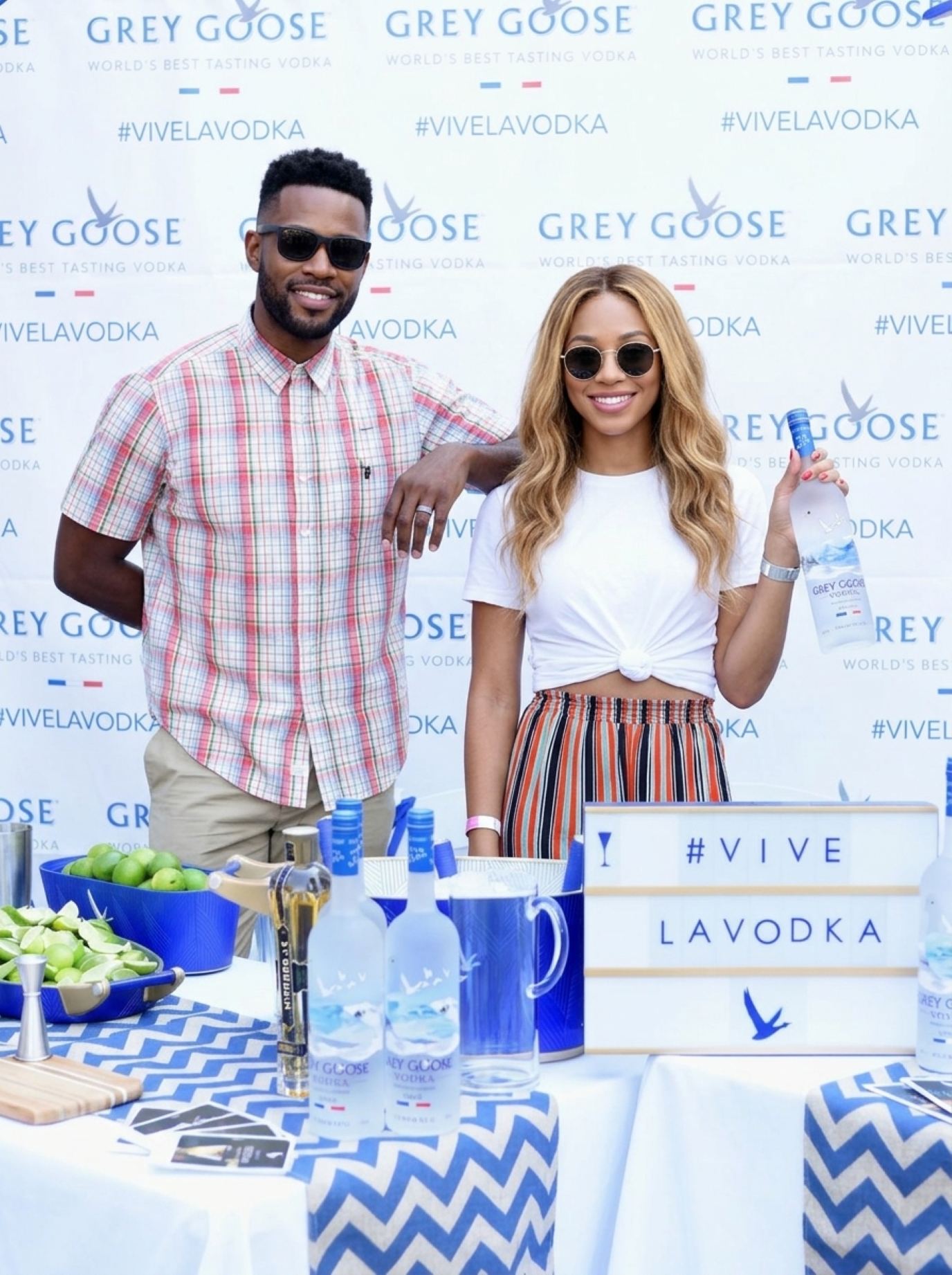 Promotional models in summer outfits and sunglasses serving samples at an outdoor beverage bar, a look that suits barbecue and patio events in Kansas City